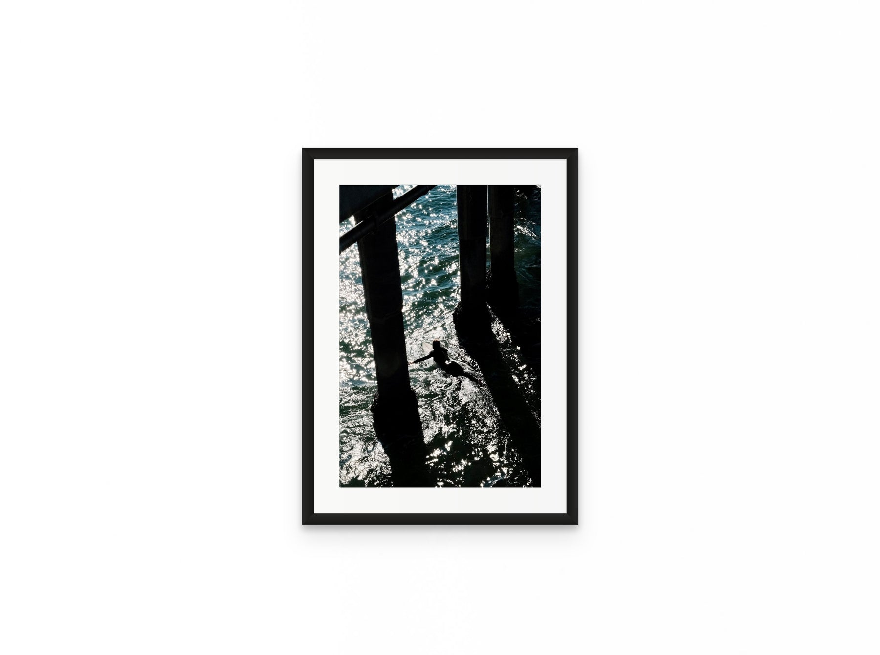 Pier Shadows Surfer, 12×18 in black frame