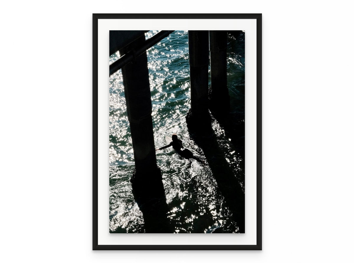 Pier Shadows Surfer, 20×30 in black frame
